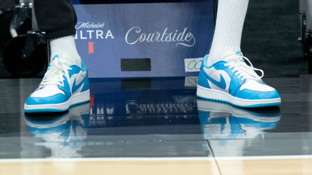 Kevin Durant wears blue and white Air Jordan sneakers on the sidelines of an NBA game.